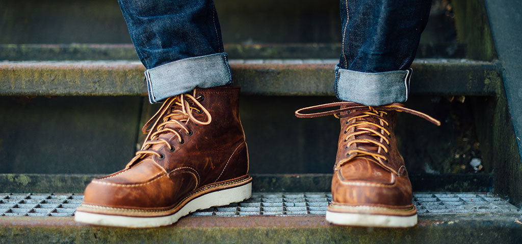 Pair of Red Wing Boots With Turned up Blue Jeans, Standing on Industrial Style Metal Steps