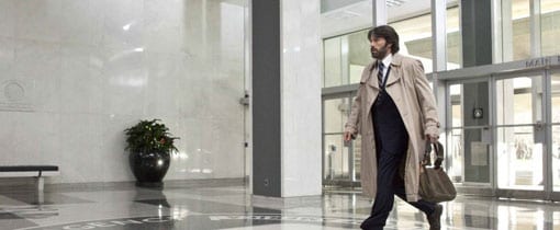 Ben Affleck in Argo with Westmorland bag in hotel foyer.