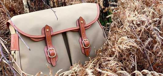 Brady Bag in a natural setting, featuring a classic canvas and leather design. High-quality, durable bags perfect for outdoor and everyday use.