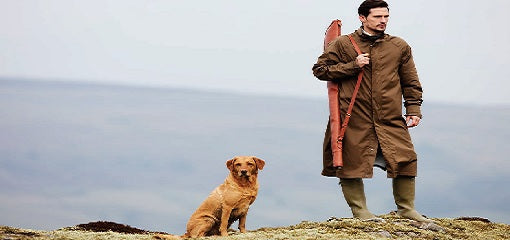 Man With Shotgun and Hunting Dog Wearing Purdey Full Length Overcoat