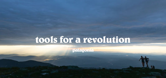 Hikers on a mountain at dawn with the text "tools for a revolution" and the Patagonia logo against a dramatic sky.